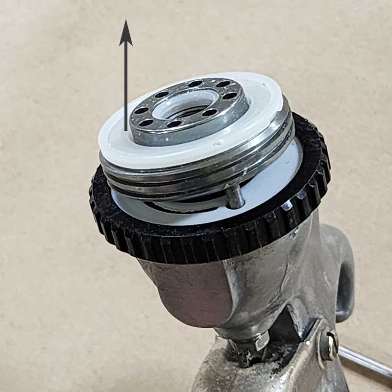 Remove the air distributor (#7) and clean if necessary.