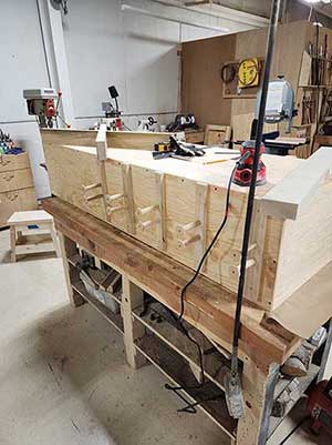 The cabinet on the bench mounting the clamp holding pegs. 